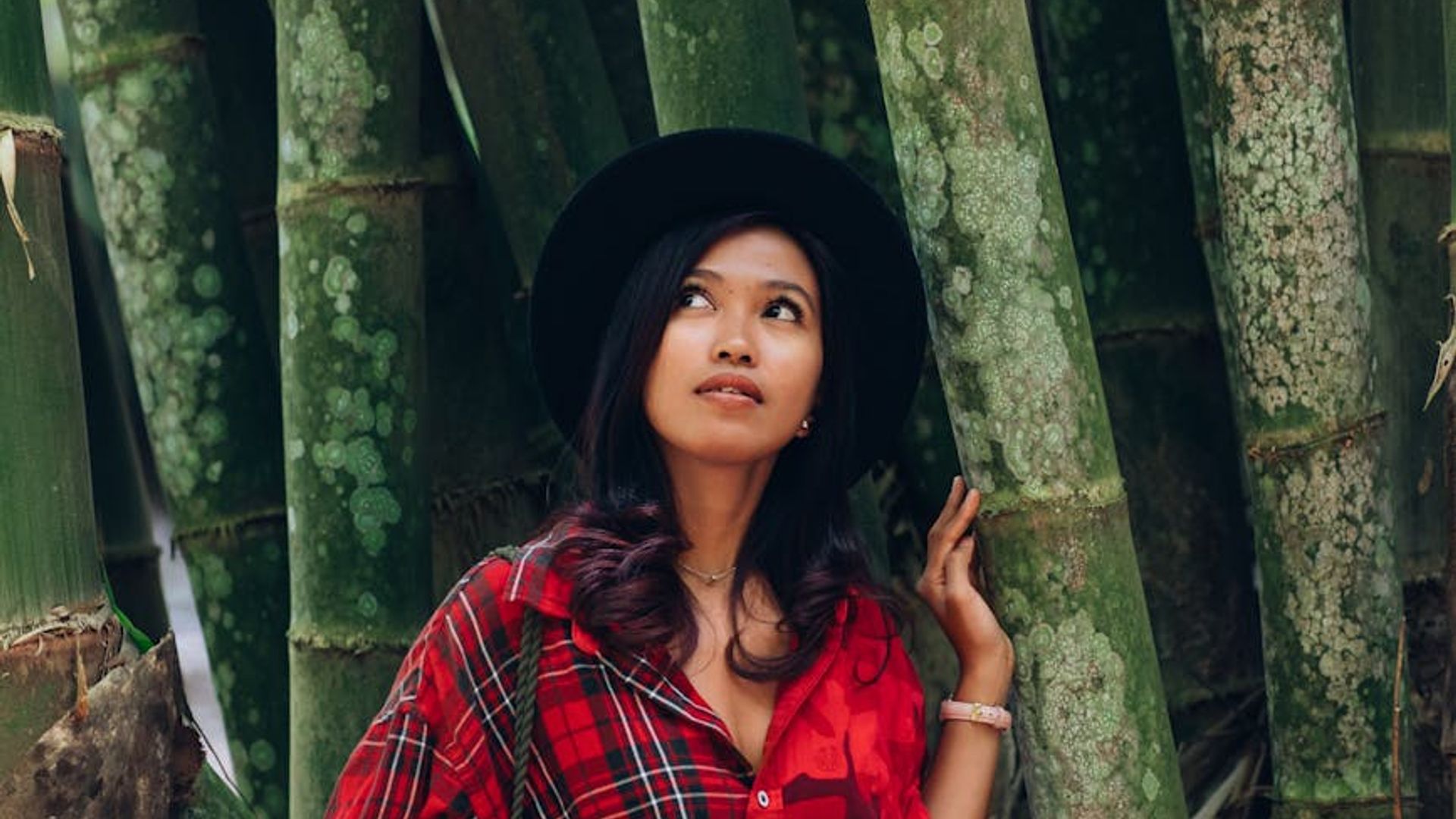 Serene person in a thoughtful yoga pose in a calm environment.